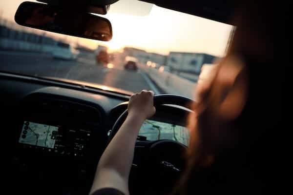 woman driving at sunset