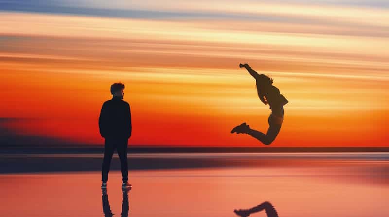 man and woman celebrating on the beach